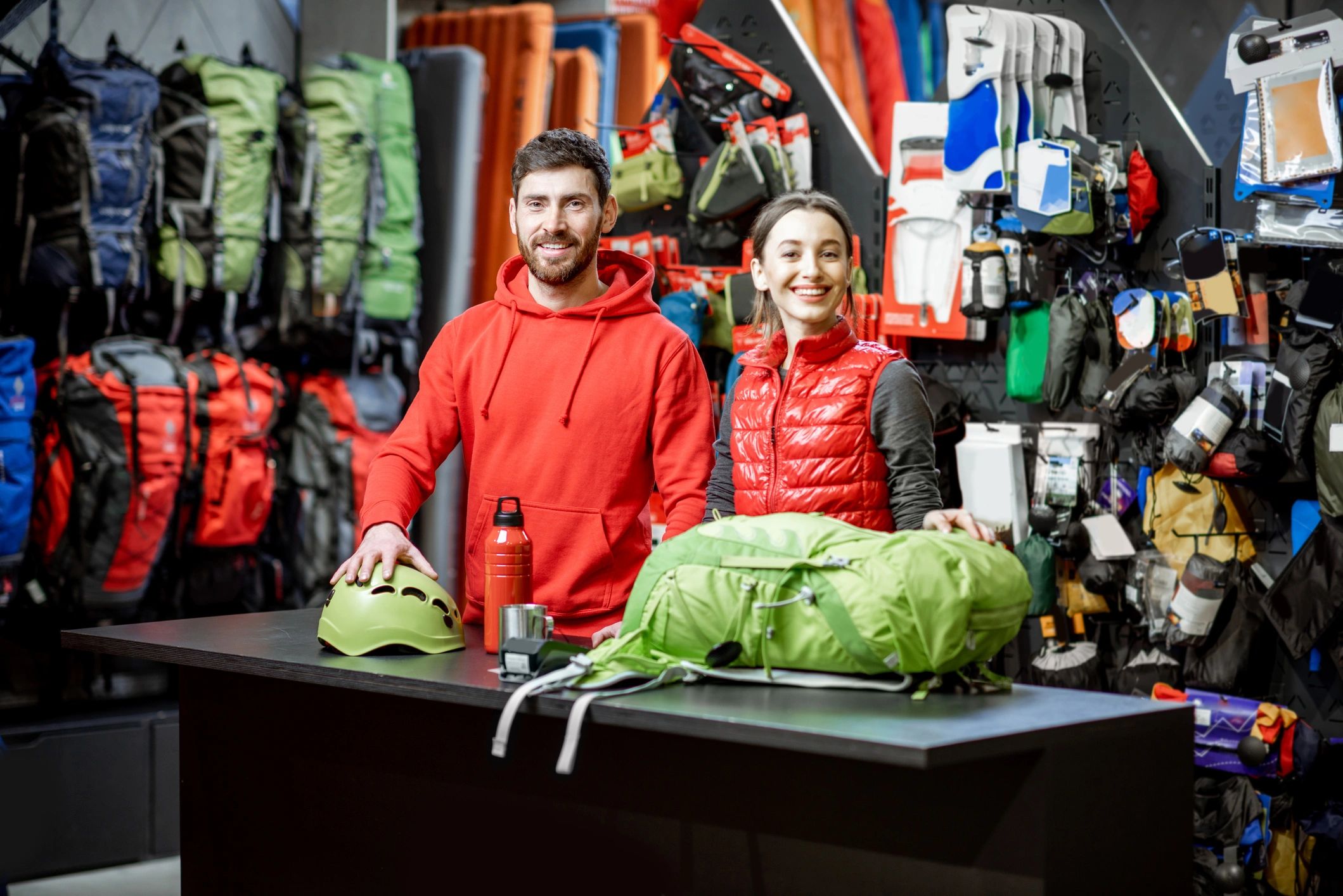 Stack of books next to pencils in a holder and a camera.