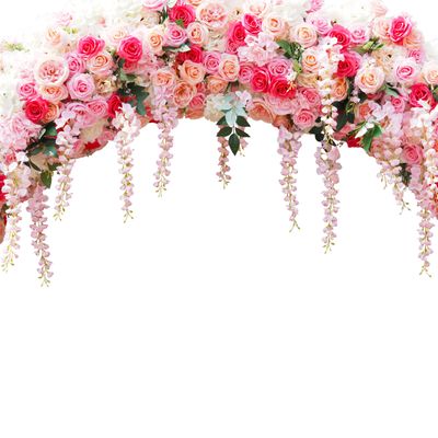 A cascading floral arch with pink and peach roses and hanging blossoms.