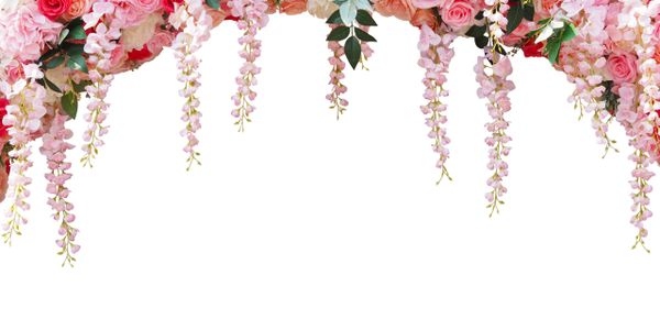 A cascading floral arch with pink and peach roses and hanging blossoms.