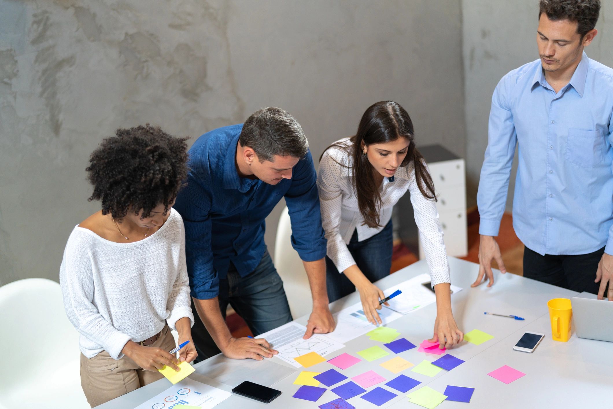 Group brainstorming session with colorful sticky notes.