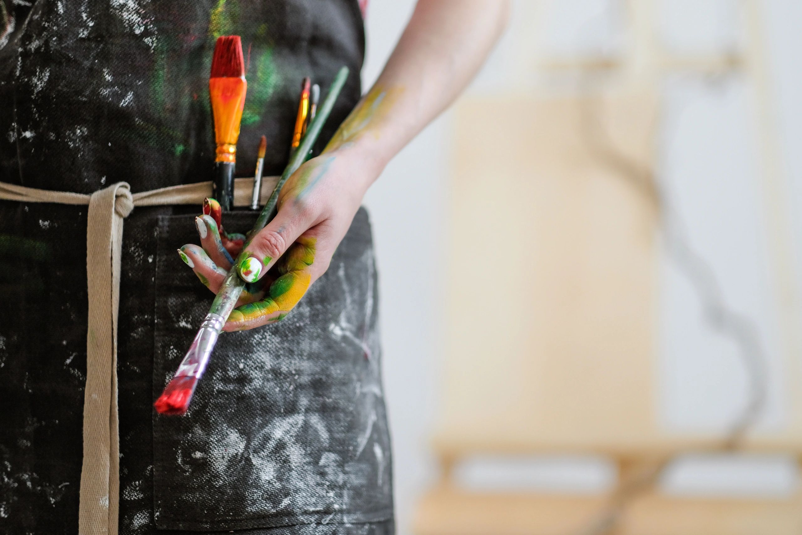 A man holds the paint brush