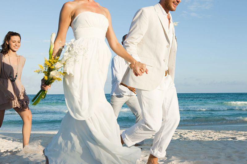 Married couple on beach with friends