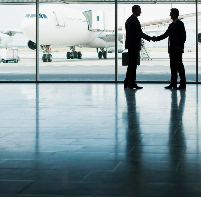 Business people shaking hands in airport