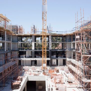 Construction site with scaffolding and a crane.