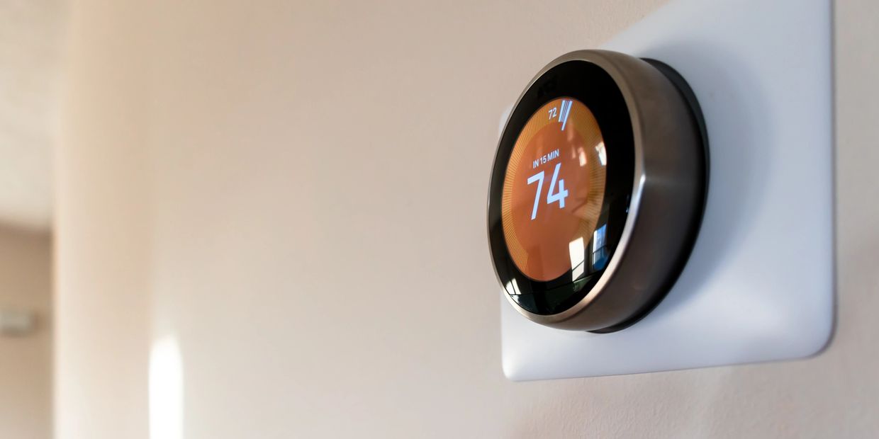Smart thermostat displaying a temperature of 74 degrees.