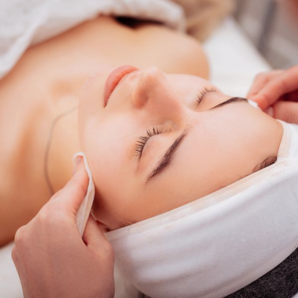 Woman enjoying a facial spa treatment.