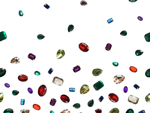 Colorful gemstones scattered on a white background.