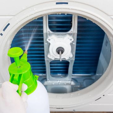 Applying child and pet safe chemical cleaner to the coils