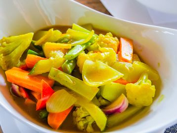 Bowl of mixed cooked vegetables.