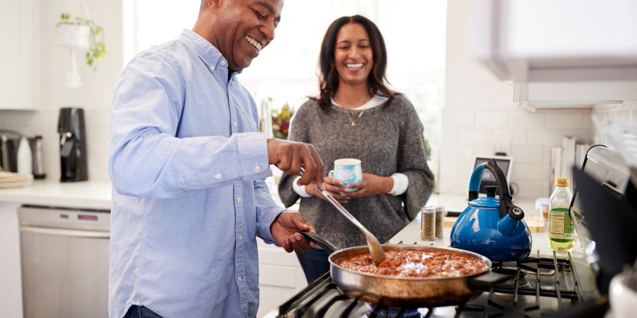 Couple cooking and enjoying time in the kitchen.