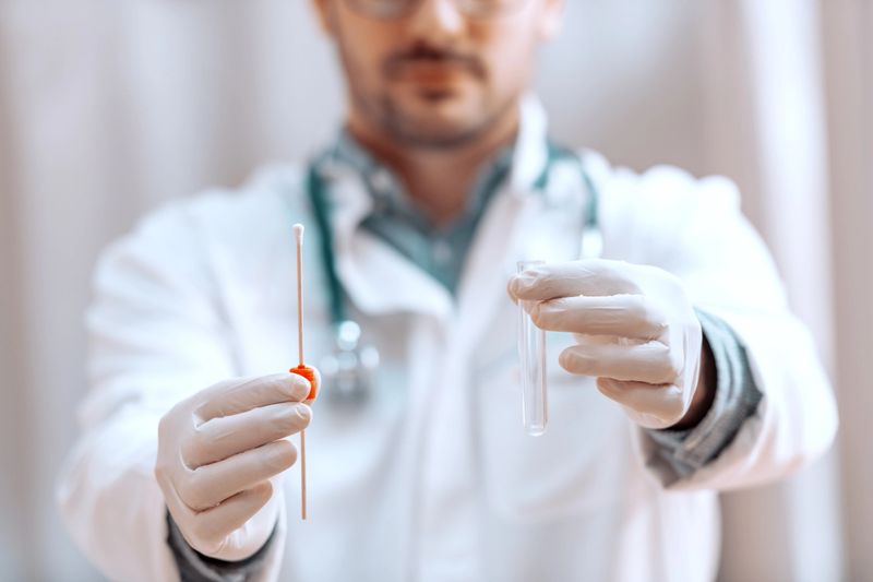 Close up of doctor holding swab with sample