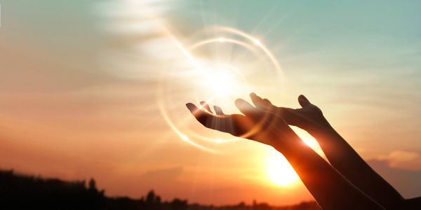 Reaching hands out for light