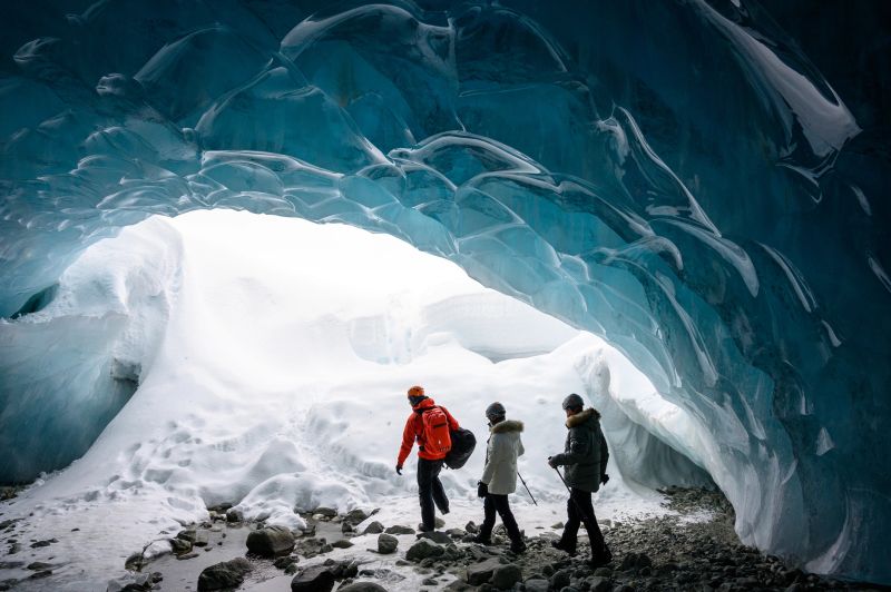 Guide and guests exploring a stunning glacial ice cave