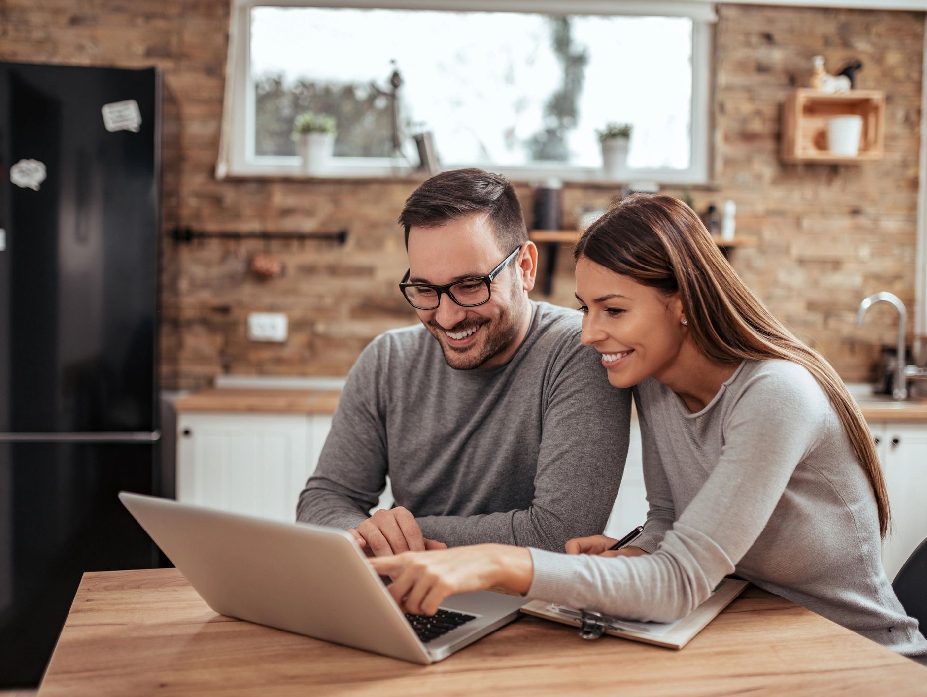A couple completing Remote Online Notarization on a laptop.
