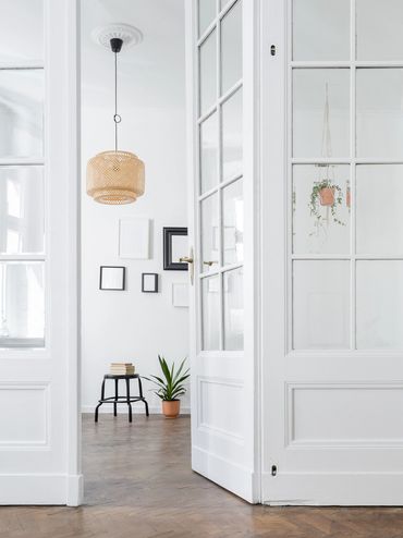 Minimalist room with white walls and wooden floor.