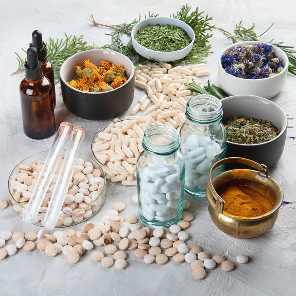 Various herbal medicines including dried herbs, capsules, tablets, and tinctures.