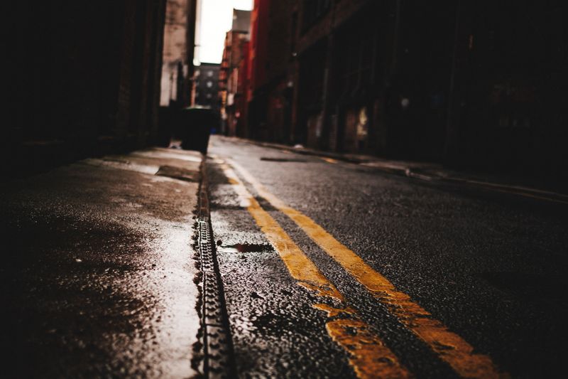 Dark gritty urban alleyway, Manchester, England.