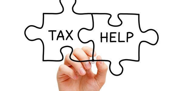 Puzzle pieces labeled 'Tax' and 'Help,' symbolizing tax resolution.