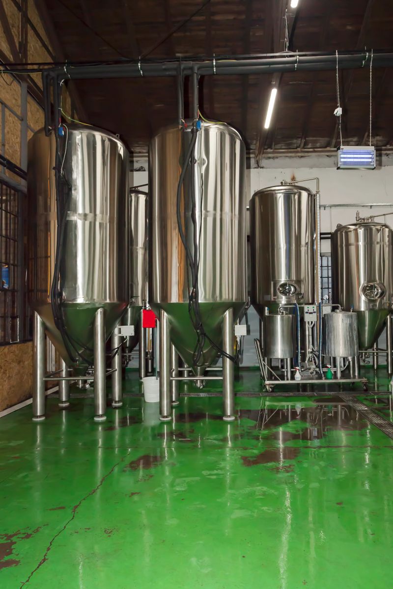 Brewery. Modern beer plant with brewing kettles, tubes and tanks made of stainless steel