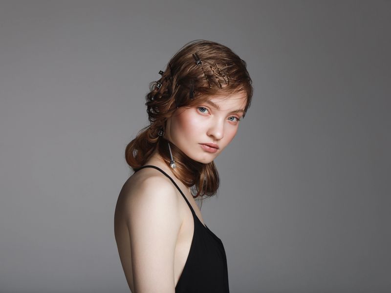 Portrait of young beautiful woman with hair clips and pins