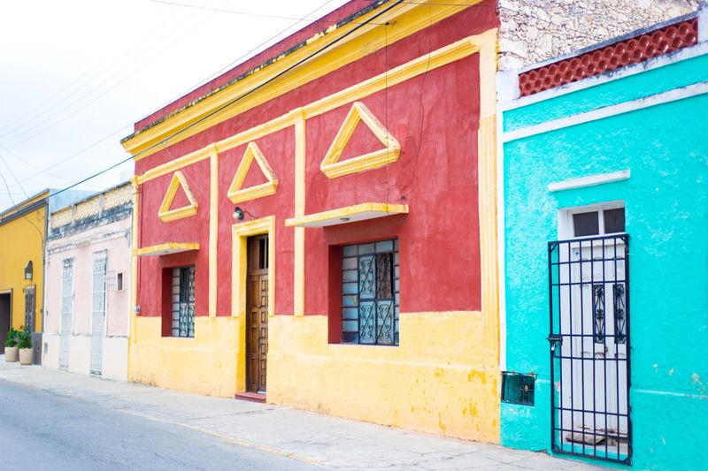 Mérida, Yucatan, Mexico: A colorful neighborhood in downtown Merida with colonial-style houses painted turquoise, red, yellow and pink.