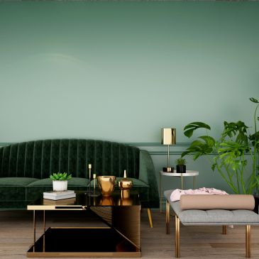 Elegant green velvet sofa with gold accents in a modern living room.