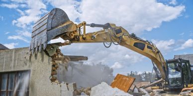 Excavator demolishing a building.