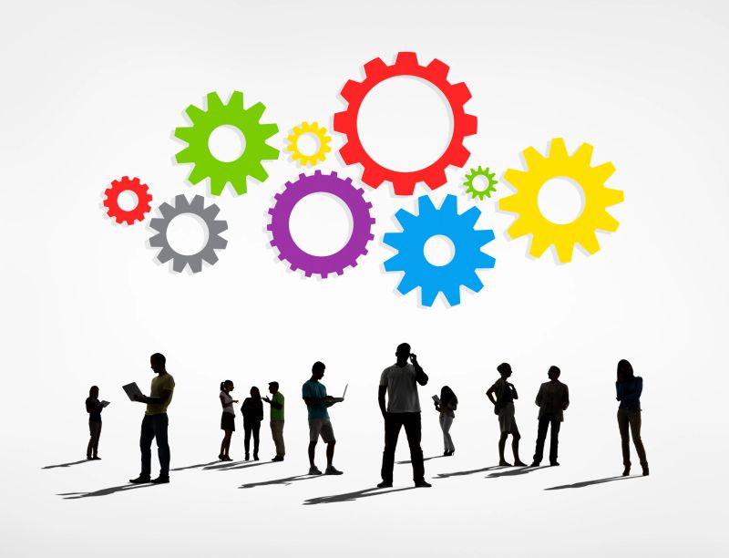 Silhouettes of Business People Working and Gears Above