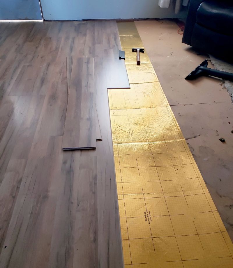 Incomplete laminate hardwood floating floor in empty room