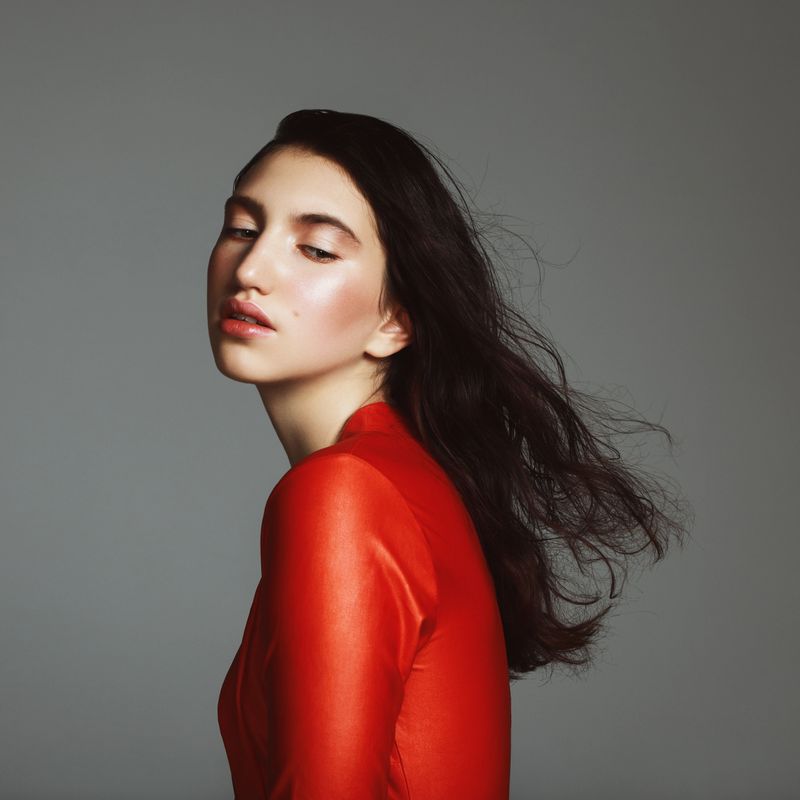 Portrait of millennial girl wearing red dress