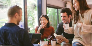 Group of friends happily chatting in a cafe.