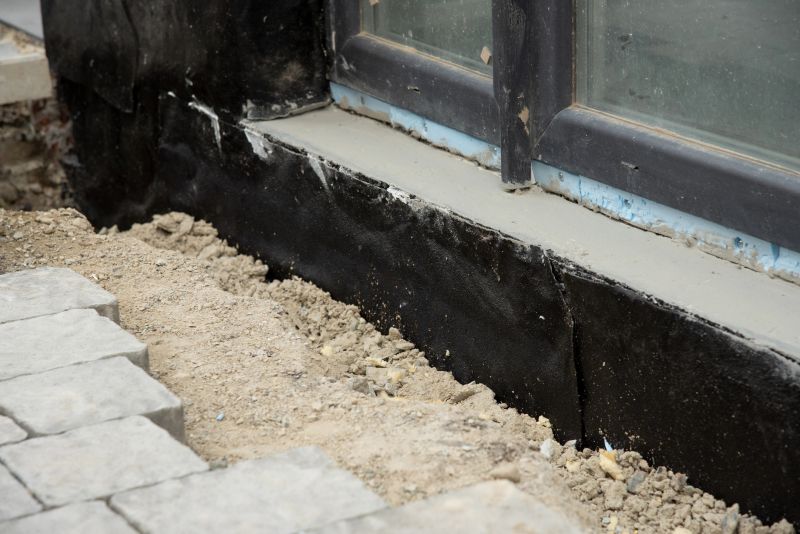 Waterproofing foundation bitumen and insulation with polystyrene foam boards for House Energy Saving. Damp proofing Coatings.Waterproofing house foundation with spray on tar.