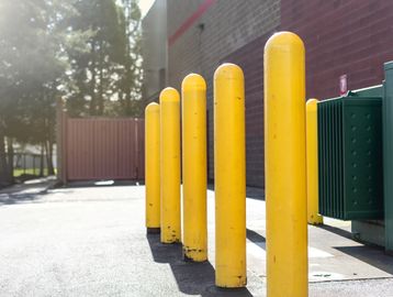 Safety yellow bollards installed to enhance safety and prevent vehicle intrusion