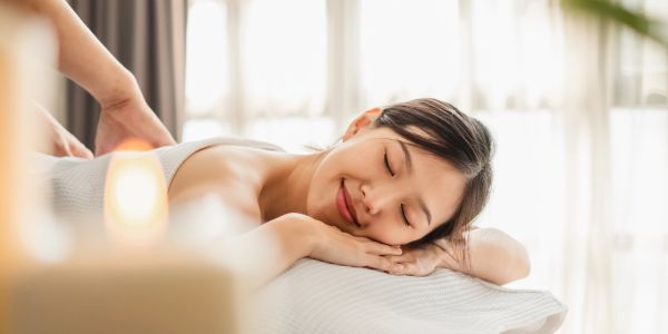 Woman enjoying a relaxing massage with eyes closed.