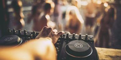 DJ mixing music at a party.