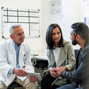 Doctor consulting a couple in a medical office.