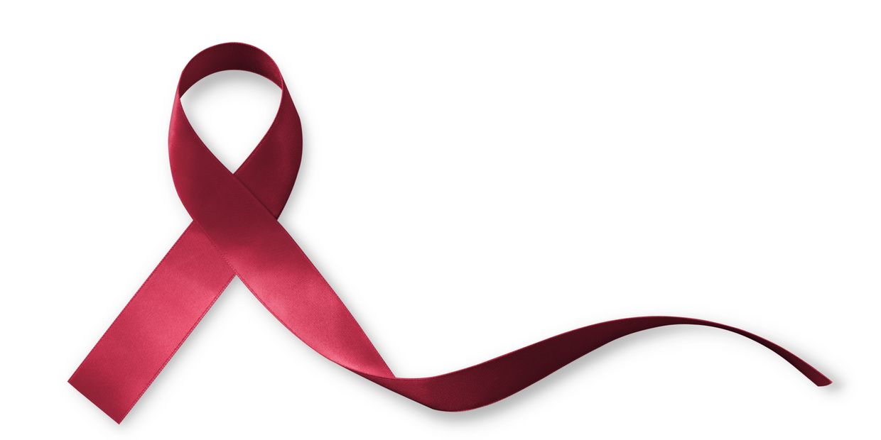 A red ribbon folded in a loop on a white background.
