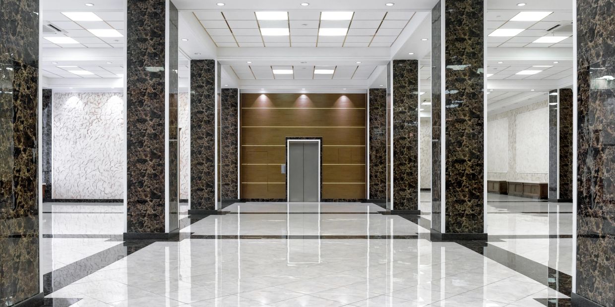 Luxurious lobby with marble columns and polished floors.