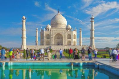 The Taj Mahal with a crowd of tourists and reflection pool.