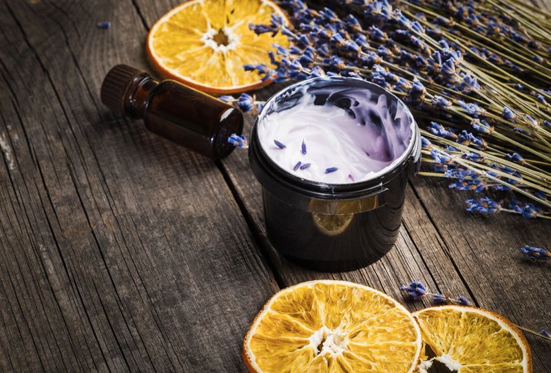 Moisturizing cream organic with a lavender and orange dry on a wooden table