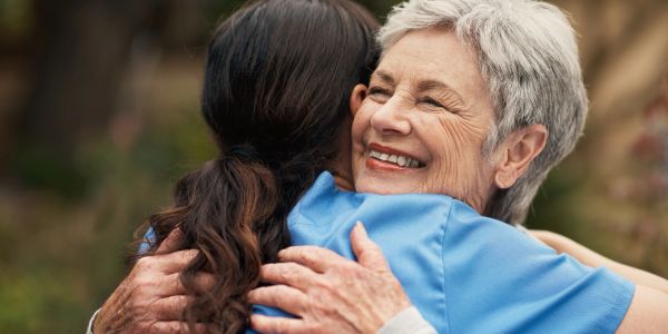 Young hands gently holding elderly hands showing care and support.