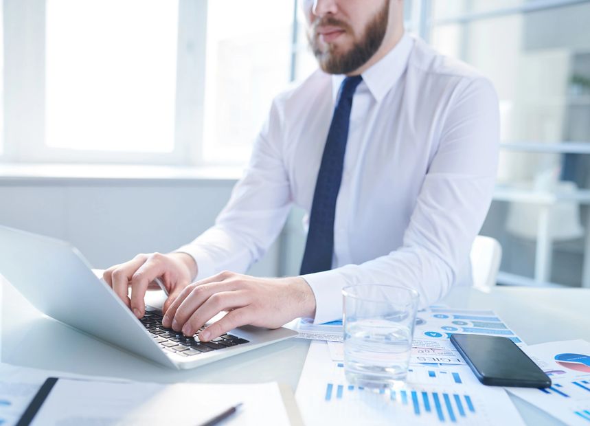 accountant entering data into a laptop