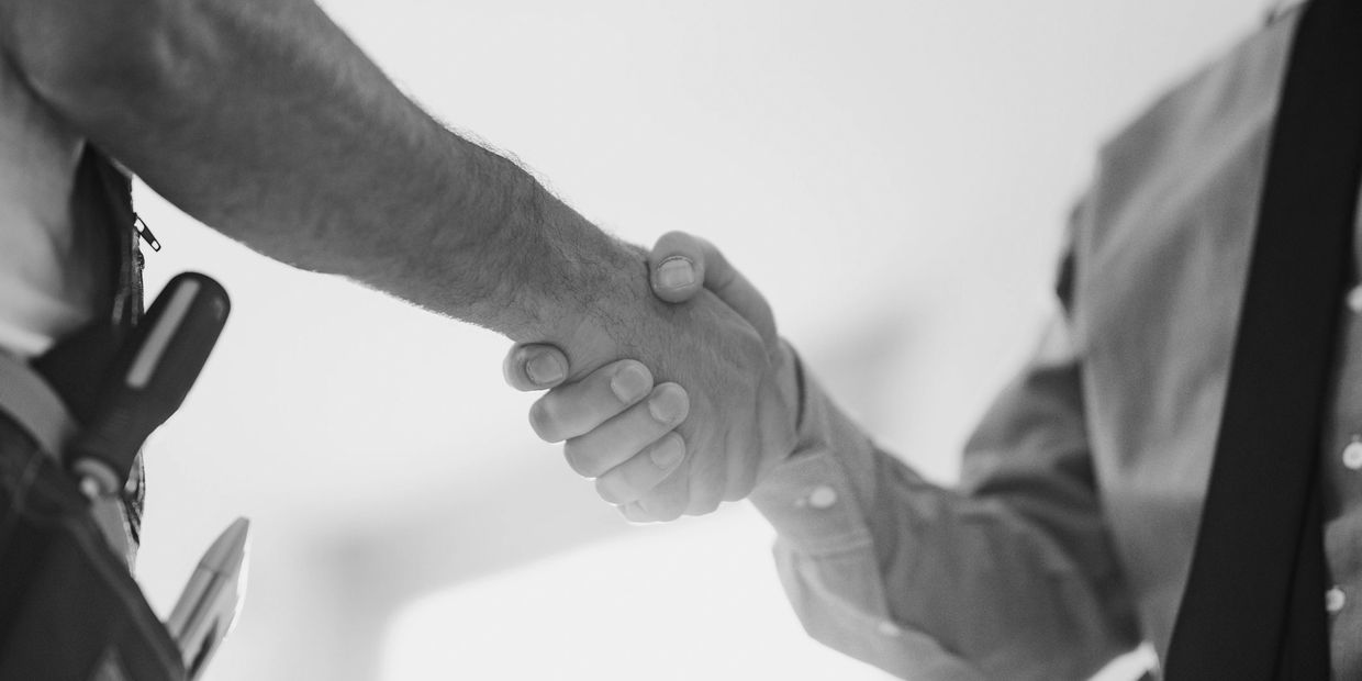 Two men shaking hands in agreement.