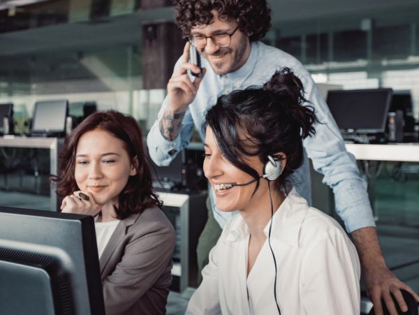 Three coworkers collaborating in an office environment.