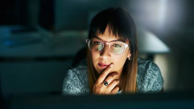 Woman intently looking at a screen.