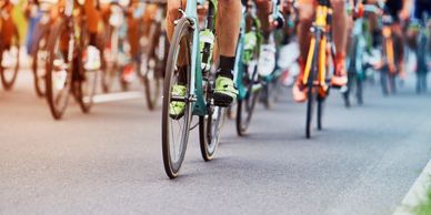 Cyclists racing closely on a paved road during a competitive event.