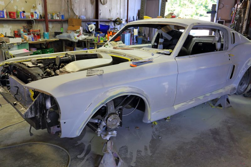interior of body shop with car being rebuilt