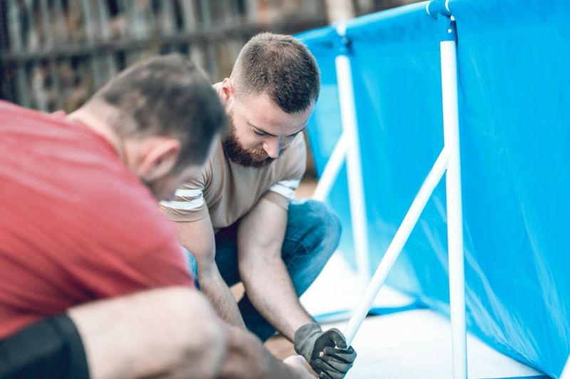 Male Technicians Solving Pool Problems In Backyard