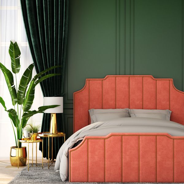 Elegant bedroom with a coral headboard and lush green accents.