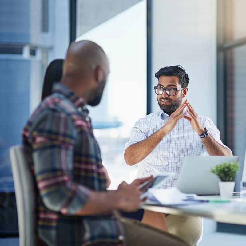 Shot of a group of young businesspeople discussing ideas with each other during a meeting in a modern office